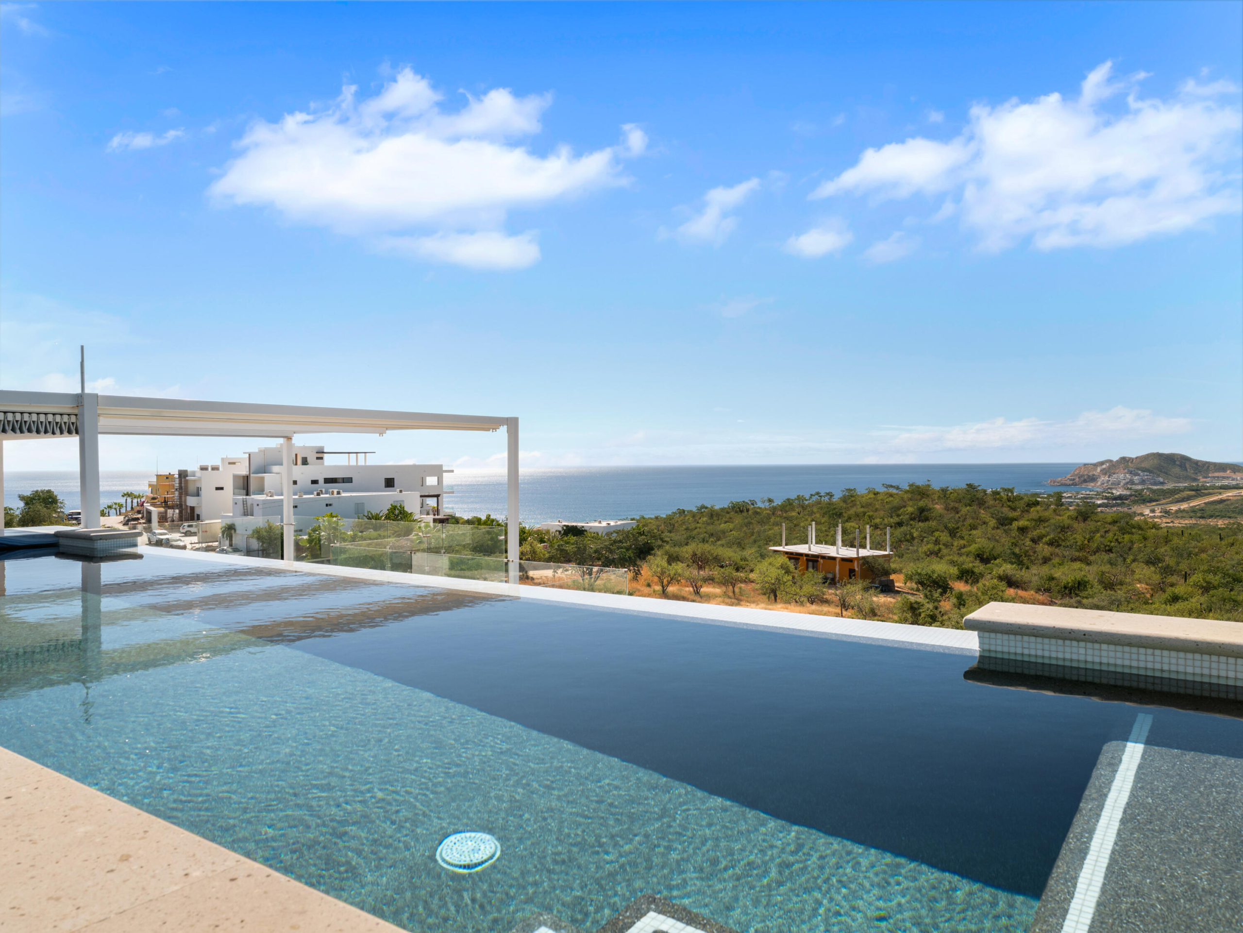 Querencia Section 4- Las Canadas Discover refined indoor-outdoor living at Cañada 9, set within Querencia, San Jose del Cabo's premier private golf community. Soaring beamed ceilings, walls of pocket glass, and luminous marble floors define an open great room that flows effortlessly to the terrace, infinity-edge pool, and stone-clad water feature -- all framed by panoramic Sea of Cortez and mountain for sale