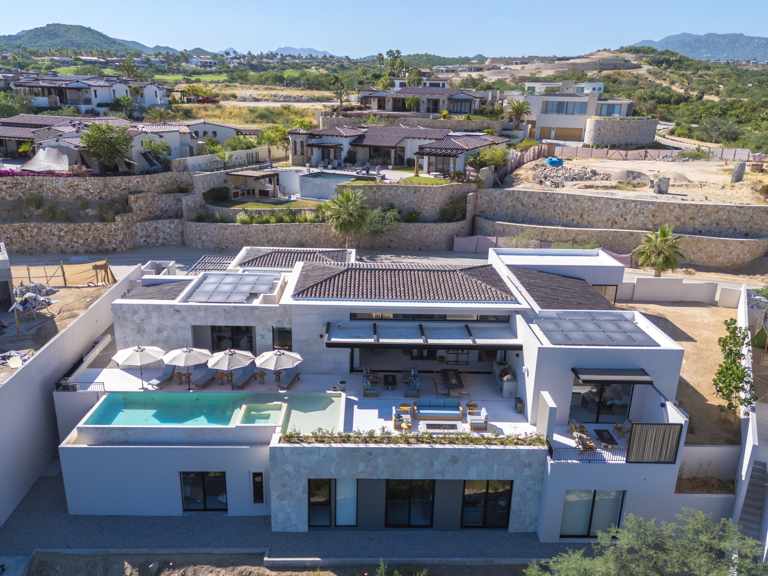 Querencia Section 18- Horizontes Welcome to Horizontes 3, an exquisite custom-made home located within San José del Cabo's most sought-after community, Querencia. Surrounded by Tom Fazio's signature golf course, recognized as one of the best in the country, this stunning residence is just a short golf cart ride from the prestigious 5-star Club House. This remarkable 6-bedroom, 6.5-bathroom home elevates luxury living with a fresh vision of architecture and design. The layout features a cozy family room, an expansive bunk bed bedroom on the lower level, and a spacious maid's quarters with an independent entrance, making it ideal for entertaining family and friends.The property boasts outdoor living spaces, including tranquil green areas, an outdoor kitchen, an infinity pool, a jacuzzi, and ocean and ravine for sale